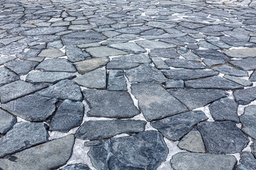 Dark stone slabs of irregular shape on the square