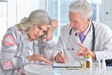 Portrait of senior doctor with elderly patient