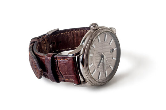 Old wristwatch with leather strap on white