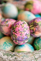 Artistically decorated Colorful easter eggs with collage in a glass bowl. Selective focus