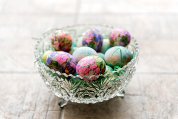 Artistically decorated Colorful easter eggs with collage in a glass bowl. Selective focus