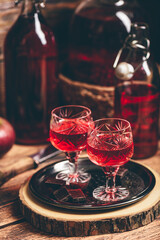 Glass of red liquor with chocolate bars