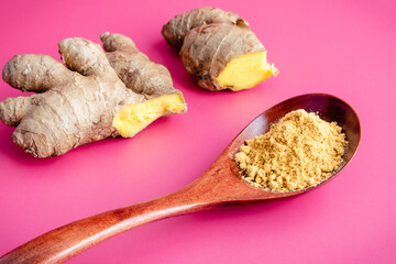 Ground Ginger with Fresh Ginger Root: A spoonful of ground ginger with raw ginger in the background