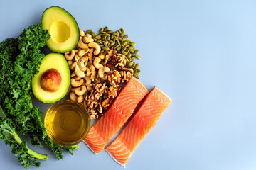Overhead View of Fresh Omega-3 Rich Foods: A variety of healthy foods like fish, nuts, seeds, fruit, vegetables, and oil rich in omega-3 nutrients - obrazy, fototapety, plakaty