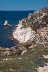 Fototapeta na wymiar View of the calm sea from the height of the mountains. Beautiful seascape. Travel to the mountains. Summer rest. Rocks, cliffs, stones.