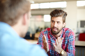Obraz premium This is how I see it.... Shot of two colleagues discussing work in the office.