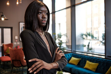 Portrait of young black model woman in a hotel lobby.