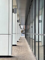A modern building with a pedestrian walkway. Glass and concrete modern architecture. Taken in Manchester England. 