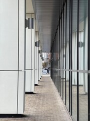 A modern building with a pedestrian walkway. Glass and concrete modern architecture. Taken in Manchester England. 