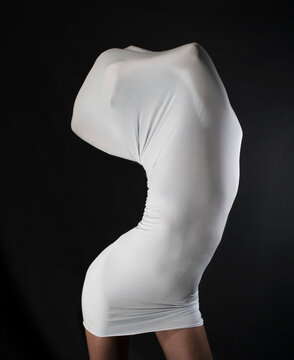 Slim woman trapped in a white skintight dress