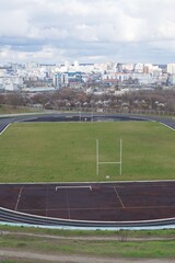 Obraz premium Empty oval sports stadium with running tracks and football field