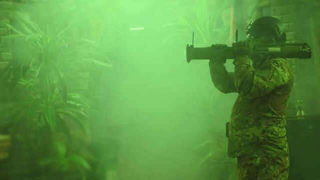 Private Military Company operator shoots from an RPG rocket launcher . Soldier with antitank grenade launcher . R. P. G. shooter shooting . Shot on ARRI movie camera in Slow Motion .