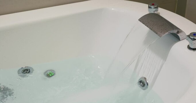 Water coming out from tap for the bathtub