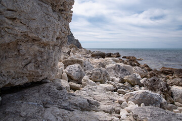 Stone mountains on the background of the sea landscape. Lime minerals. Geology near the ocean. Natural background.
