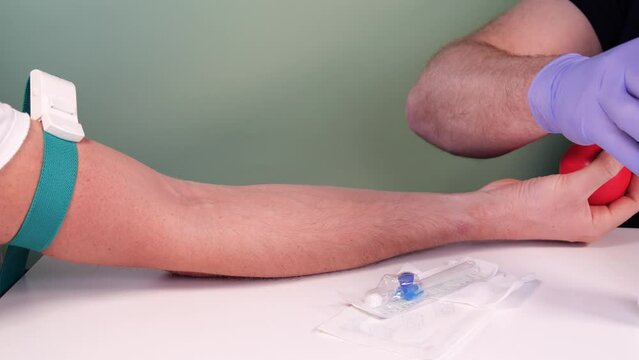 Blood donation concept. Injection for blood collection. Nurse or paramedic prepares the patient for blood donation. Blood test preparation. 