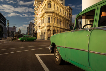 Old car on streets of Havana with colourful buildings in background. Cuba