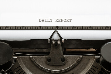 Daily Report headline written on vintage type writer from 1920s