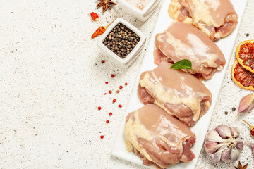 Raw chicken thigh without bones or skin. A useful ingredient for preparing healthy food, spices