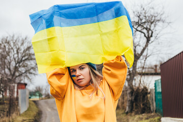 Ukrainian girl holding ukrainian flag