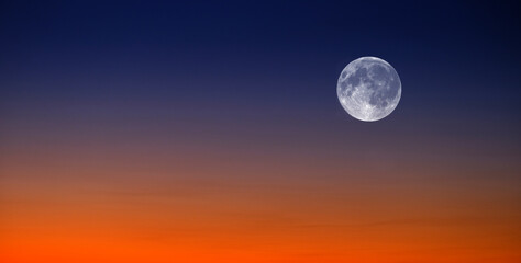 Sunset and Full Moon at Sunset or Sunrise on Horizon Orange and Blue Light