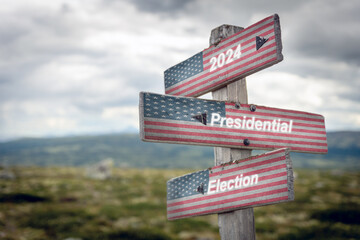 2024 presidential election text quote on wooden signpost outdoors with the american flag on it. Politics and voting concept.