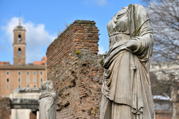 Fototapeta na wymiar Sculptures at ruins of the ancient roman forum in Rome, Italy