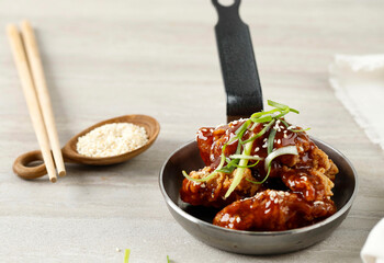 Korean Fried Chicken Yangnyeom Tongdak with Spicy Sauce and Sesame Seed.