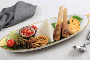 Nasi Campur Bali. Balinese Dish of Steamed Rice with Variety of Side Dishes, such as Sate Lilit, Ayam Pelalah