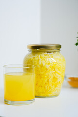 Fermented cabbage with turmeric. Cabbage kvass. Pickling vegetables without salt. Fermentation. Vitamin treatment and nutrition. Organic turmeric powder and green leaves of houseplant in a frame.