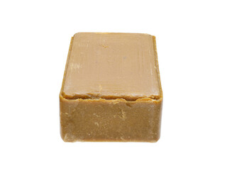 A piece of craft soap, brown in color. On a white background, close-up