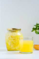 Fermented cabbage with turmeric. Cabbage kvass. Pickling vegetables without salt. Fermentation. Vitamin treatment and nutrition. Organic turmeric powder and green leaves of houseplant in a frame.