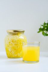 Fermented cabbage with turmeric. Cabbage kvass. Pickling vegetables without salt. Fermentation. Vitamin treatment and nutrition. Organic turmeric powder and green leaves of houseplant in a frame.