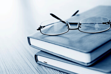 Glasses and books on wooden table