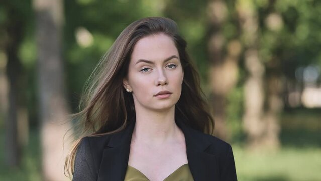 Portrait of a young student in a city park.