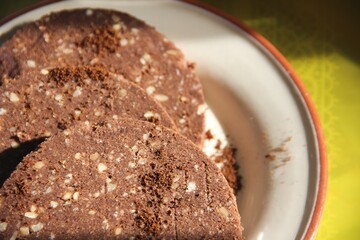 Sweet delicious chocolate dessert cut into pieces and sprinkled