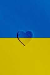 Stop war in Ukraine concept with heart and Ukrainian flag background. 