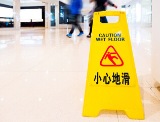 Yellow warning sign wet floor
