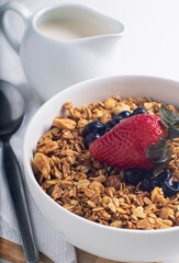 healthy breakfast with granola and strawberries at sunrise