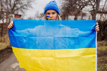 Ukrainian girl holding ukrainian flag