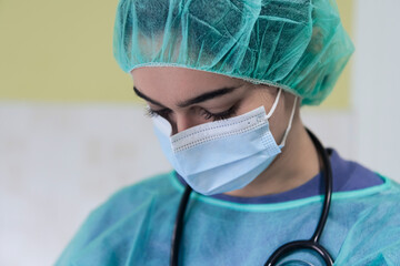 Portrait of sad and overwhelmed doctor wearing protective face mask, looking exhausted depressed and worried due to coronavirus outbreak. Emotional stressed, health care workers and COVID-19.