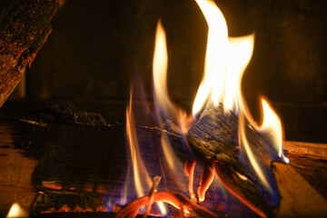 Fototapeta premium fireplace with burning logs in the dark