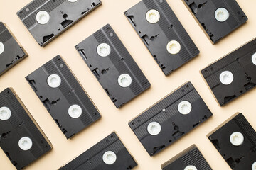 Pattern made with old tape VHS cassette on color background, top view