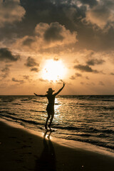 Young attractive latin girl playing at the beach on a sunny afternoon