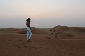 Girl posing in the sand in the desert