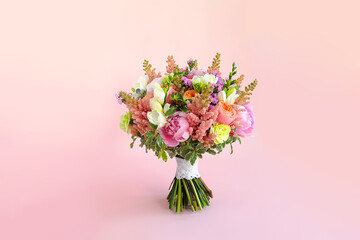 Wedding bouquet with peonies, astilbe, freesia, peony roses Juliet, limonium, dianthus and...