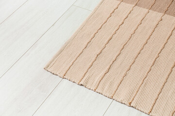 Naklejka na ściany i meble New stylish carpet on light wooden floor