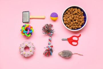 Set of pet care accessories with food on pink background