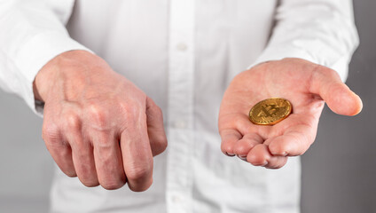 Businessman hand closeup holding bitcoin. Focus with coin. Manipulation, trading and transaction with cryptocurrency concept. High quality photo