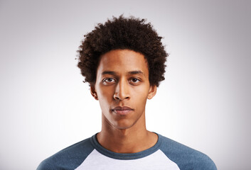 Fototapeta premium Im not here to be average.... Studio shot of a young man posing against a gray background.