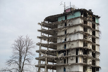 View of demolished building on cloudy sky background - obrazy, fototapety, plakaty